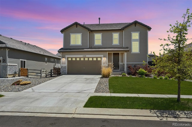 16268 Mount Silverheels Way, Broomfield, CO 80023 - view of front of house with stone siding, driveway, and an attached garage