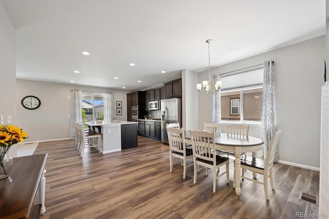16268 Mount Silverheels Way, Broomfield, CO 80023 - dining space with a chandelier, dark wood-style floors, recessed lighting, and baseboards