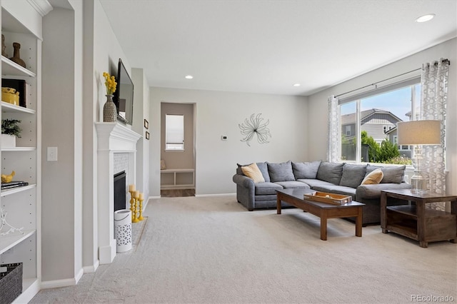 16268 Mount Silverheels Way, Broomfield, CO 80023 - living area featuring light colored carpet, a fireplace with flush hearth, recessed lighting, and baseboards
