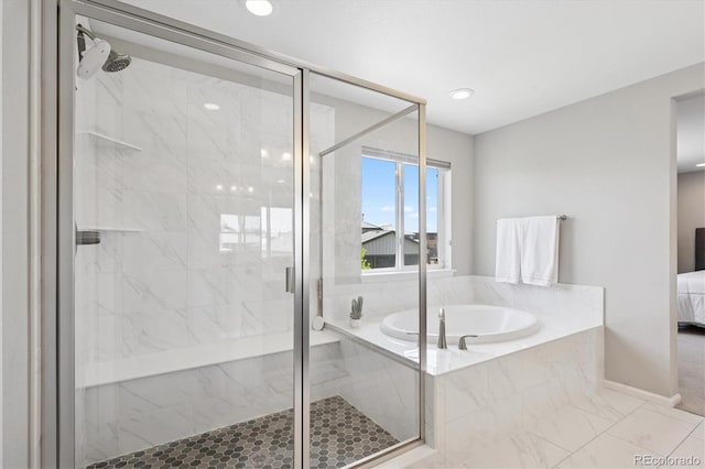 16268 Mount Silverheels Way, Broomfield, CO 80023 - full bath featuring a bath, a stall shower, ensuite bathroom, marble look tiles, and baseboards