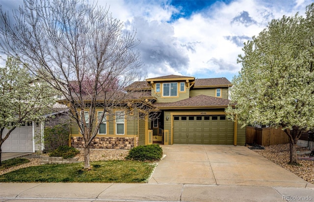 view of front of property featuring an attached garage, driveway, fence, and roof with shingles