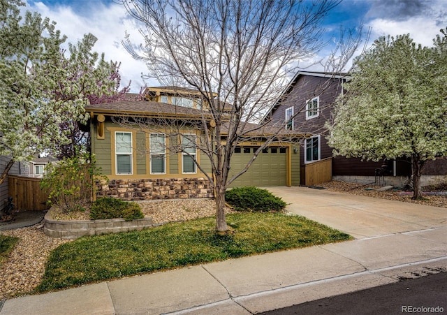 view of front of house featuring an attached garage, fence, and concrete driveway