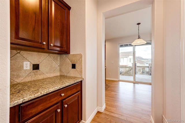 interior space featuring light wood-style flooring and baseboards