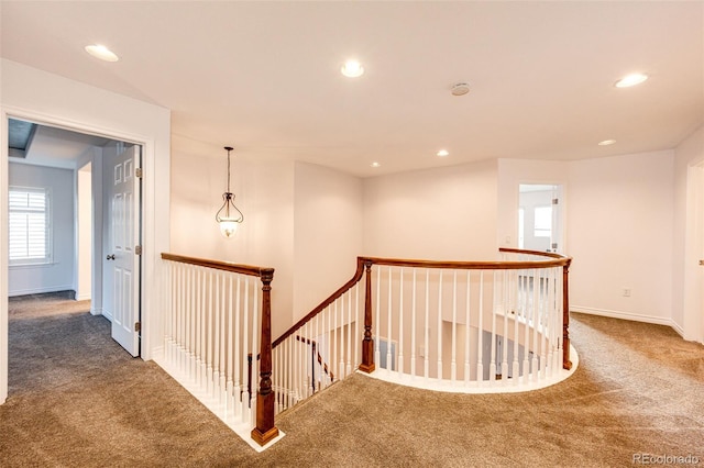hall with recessed lighting, carpet floors, and an upstairs landing