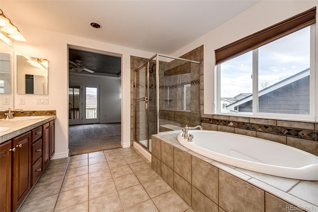 full bath featuring a bath, a sink, tile patterned flooring, a shower stall, and ceiling fan