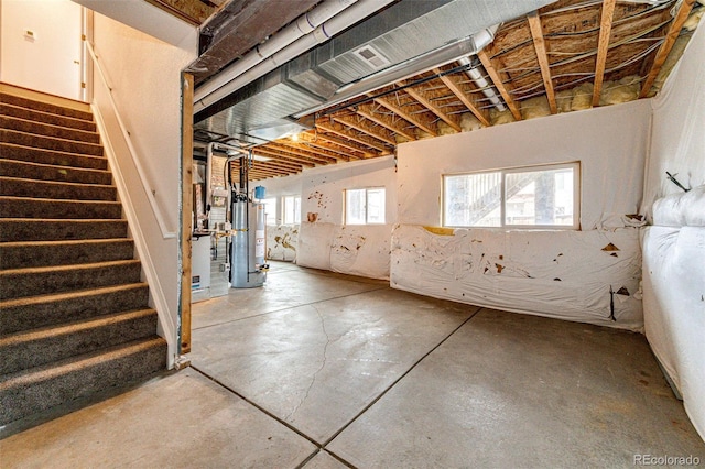 basement with water heater and stairs