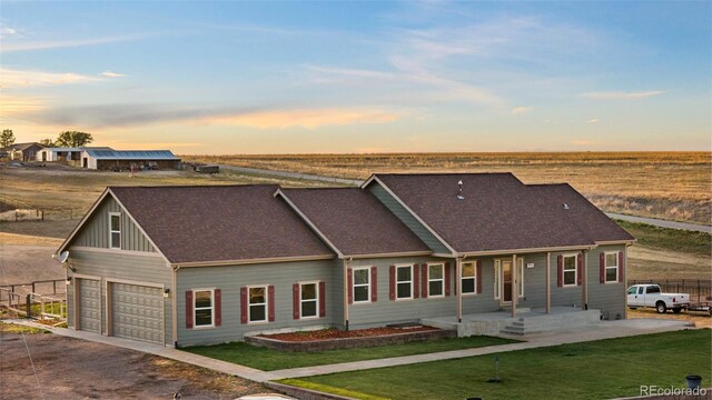 view of front of home featuring a lawn and a garage