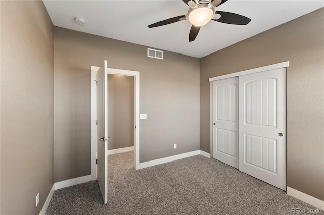 unfurnished bedroom with ceiling fan, a closet, and carpet