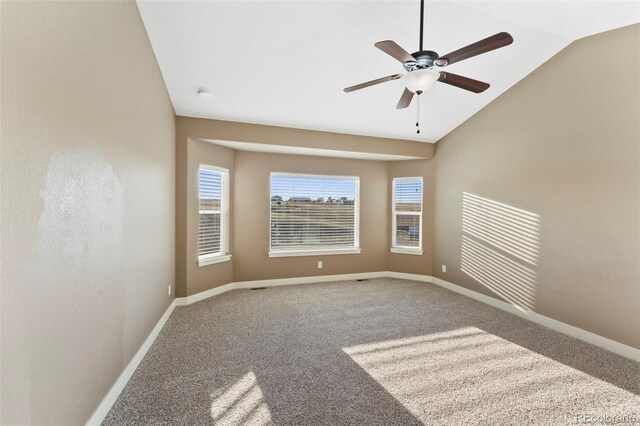 empty room featuring ceiling fan, lofted ceiling, and carpet