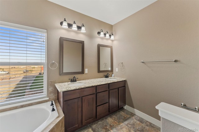 bathroom with vanity and tiled bath