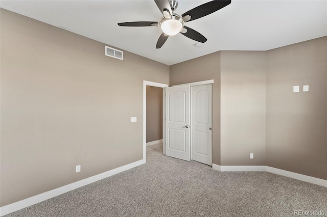 unfurnished bedroom featuring light carpet and ceiling fan