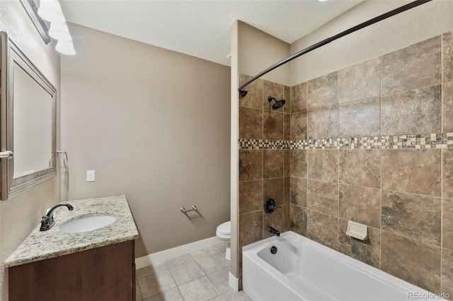 full bathroom with tile patterned floors, tiled shower / bath combo, vanity, and toilet