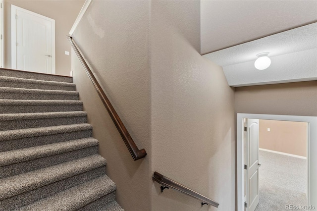 stairway with carpet floors and lofted ceiling