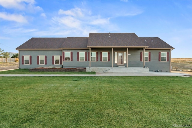 rear view of property with a lawn and a patio