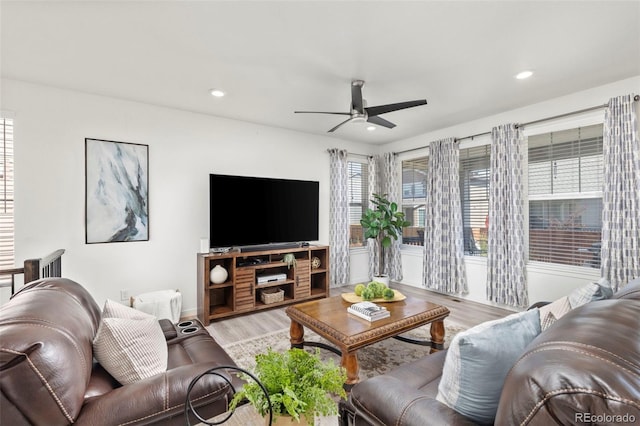 living room featuring a ceiling fan, recessed lighting, and wood finished floors