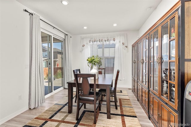 dining room featuring recessed lighting, baseboards, and light wood-style flooring