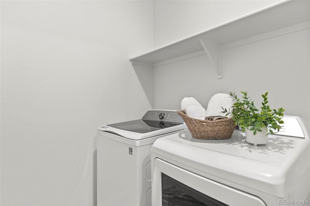 clothes washing area featuring laundry area and independent washer and dryer