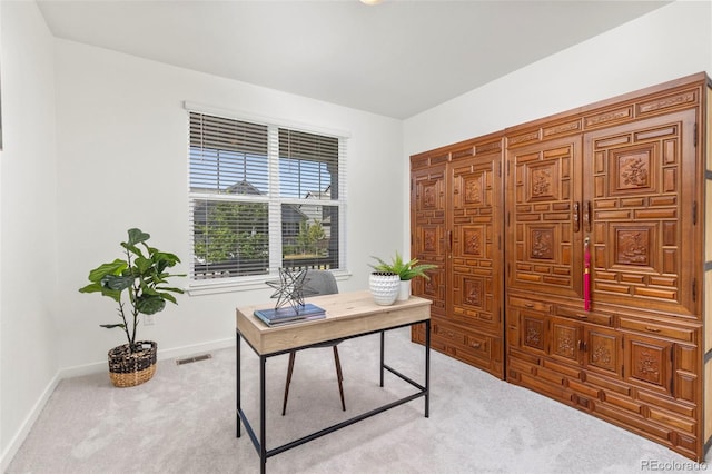 carpeted home office featuring visible vents and baseboards