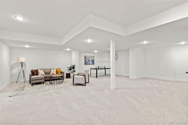 living room featuring recessed lighting, baseboards, light carpet, and a tray ceiling