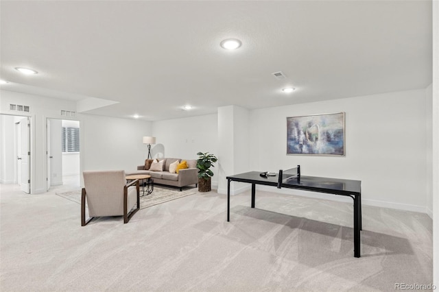 living room featuring baseboards, recessed lighting, and light colored carpet