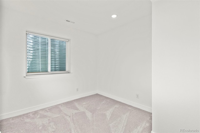 carpeted spare room with baseboards, recessed lighting, and visible vents