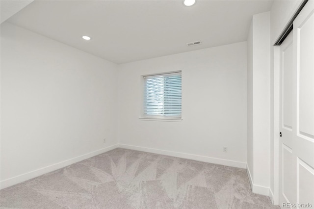 unfurnished bedroom featuring visible vents, recessed lighting, baseboards, and light carpet