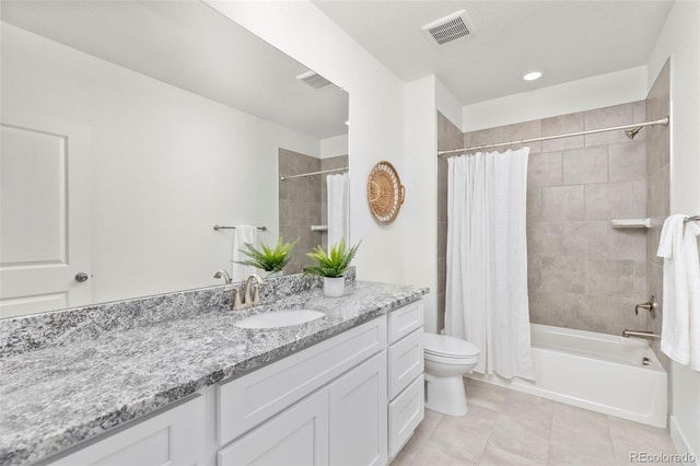 bathroom featuring visible vents, tile patterned flooring, vanity, toilet, and shower / tub combo