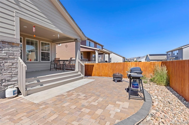 view of patio featuring a porch, fence, and area for grilling