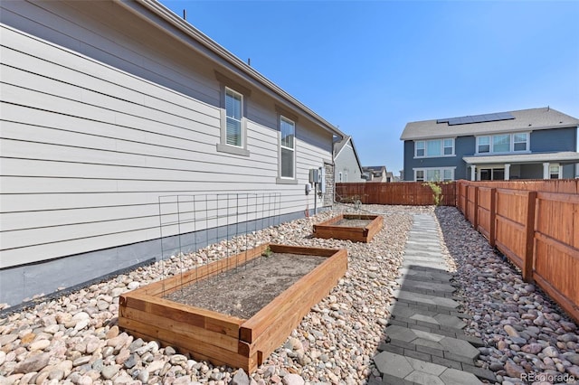 view of yard with a garden and a fenced backyard