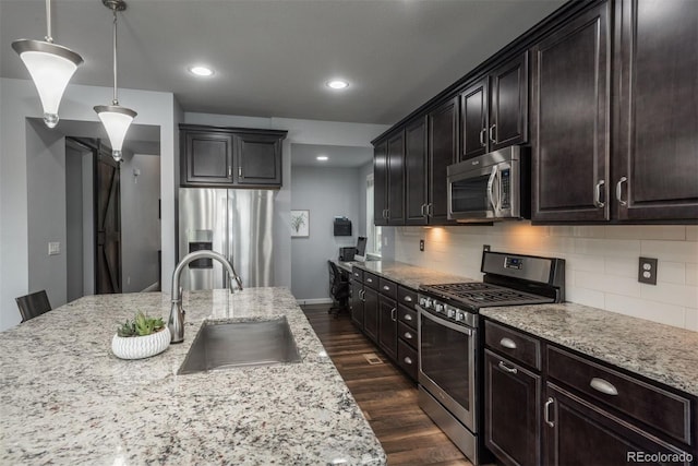 4025 Trail Stone Cir, Castle Rock, CO 80108 - kitchen featuring stainless steel appliances, backsplash, light stone counters, dark wood finished floors, and recessed lighting