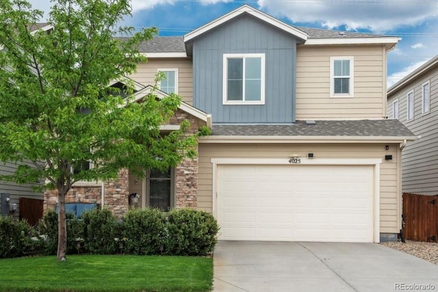 4025 Trail Stone Cir, Castle Rock, CO 80108 - view of front facade with driveway, an attached garage, stone siding, and a shingled roof