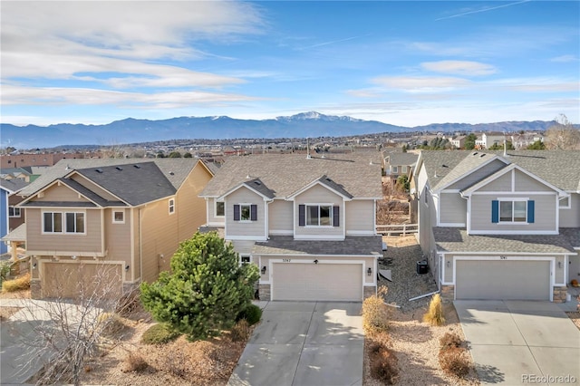 view of front of house with a mountain view and a garage