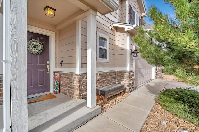 view of exterior entry with a garage