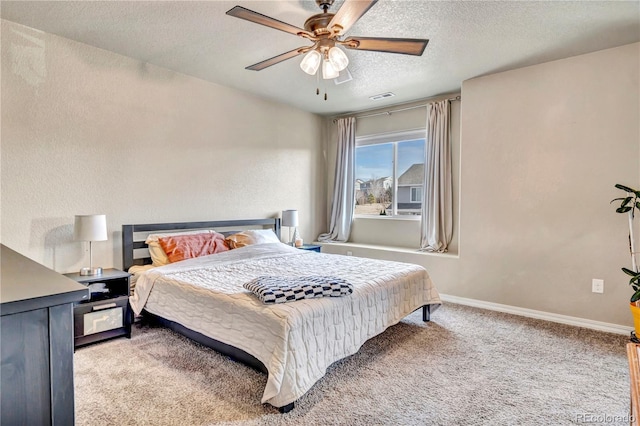 carpeted bedroom featuring a textured ceiling and ceiling fan