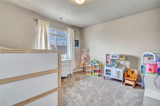 game room featuring carpet and a textured ceiling