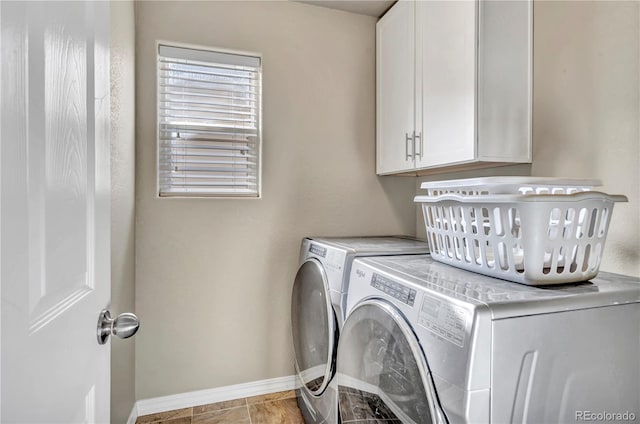 laundry room with cabinets and washing machine and clothes dryer