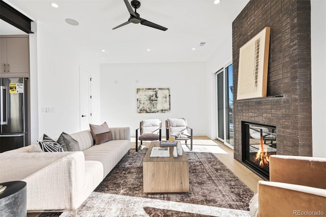 living room with recessed lighting, a fireplace, and visible vents