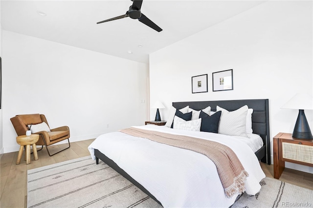 bedroom with baseboards, wood finished floors, and a ceiling fan