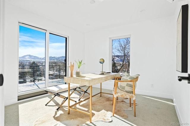 office with a healthy amount of sunlight, a mountain view, carpet, and baseboards