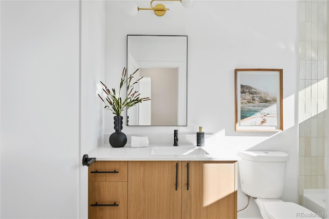 bathroom featuring toilet and vanity