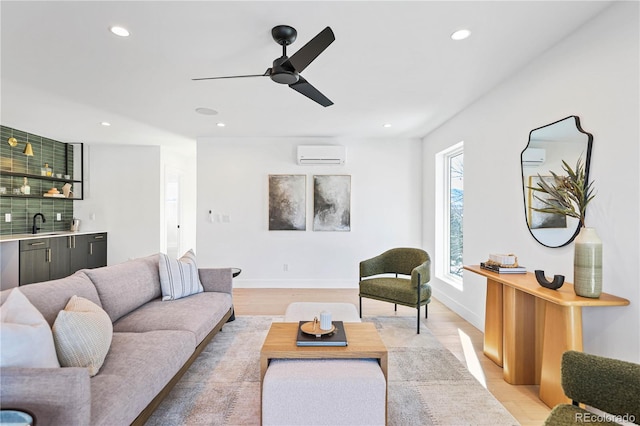 living room with indoor wet bar, a wall unit AC, recessed lighting, and light wood-style floors