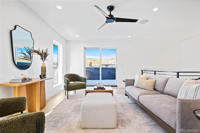 living area with recessed lighting, baseboards, light wood finished floors, and ceiling fan