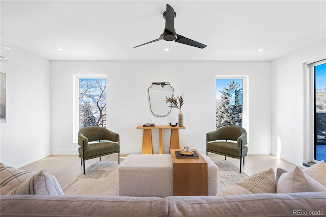 living area featuring plenty of natural light, recessed lighting, and light wood finished floors