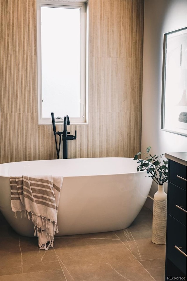 bathroom featuring vanity and a freestanding tub