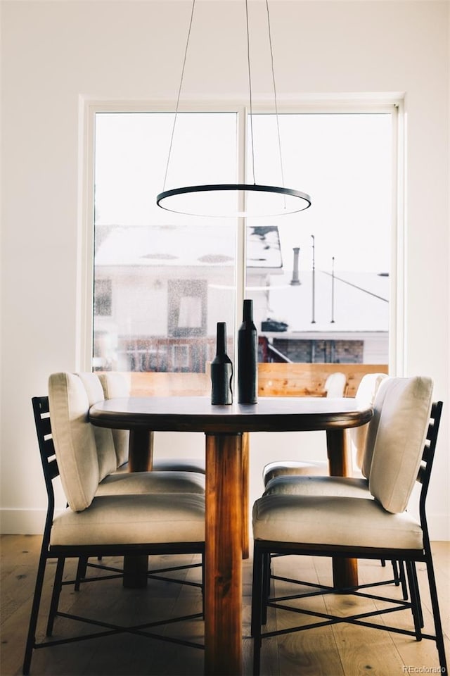 dining area featuring plenty of natural light, wood finished floors, and baseboards