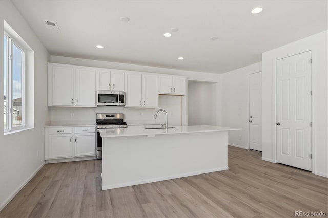 1306 Sienna Peak Cir, Erie, CO 80516 - kitchen featuring white cabinets, a sink, and stainless steel appliances