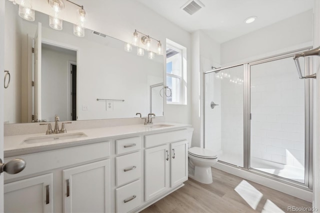 1306 Sienna Peak Cir, Erie, CO 80516 - bathroom with visible vents, a sink, and a stall shower