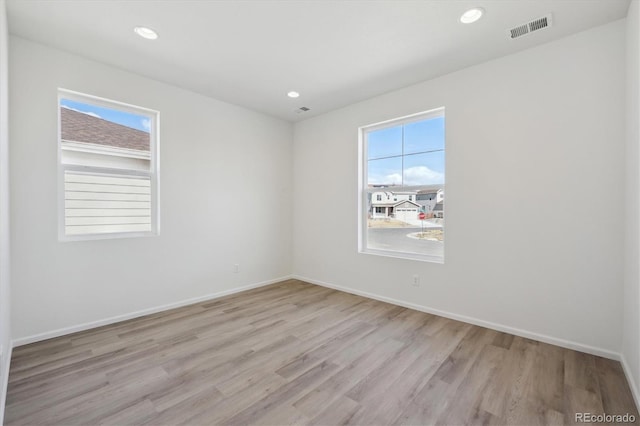 1306 Sienna Peak Cir, Erie, CO 80516 - unfurnished room with recessed lighting, baseboards, light wood-style floors, and visible vents