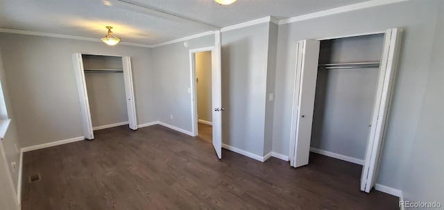 unfurnished bedroom with dark wood-style floors, crown molding, and baseboards