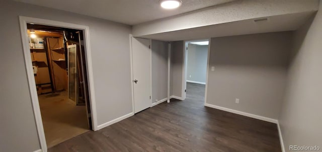 finished basement with dark wood finished floors and baseboards